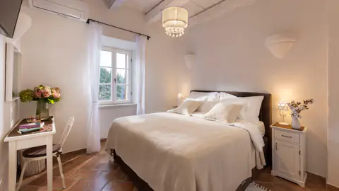 Private bedroom suite with restored stone-house character.