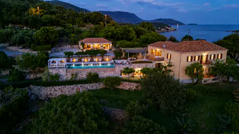 Molonta Heritage Estate illuminated at night above the Adriatic.