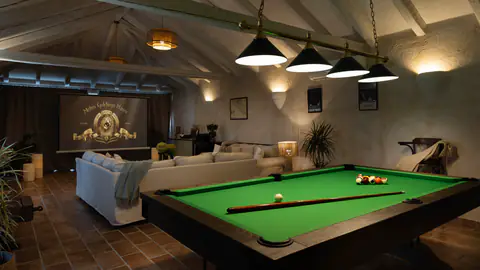 Bright indoor lounge with garden access and Mediterranean plants.