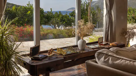 Sunlit interior sitting area connecting the house and terrace.