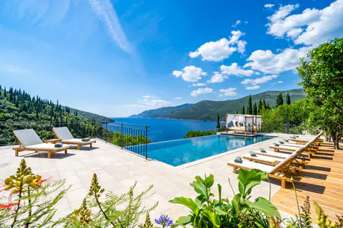 Wide panorama of the infinity pool, sun terrace, and Adriatic horizon.