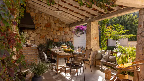 Sun loungers arranged on a shaded Mediterranean terrace.