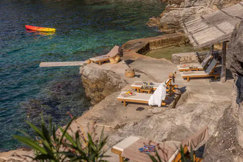 Private stone terrace furnished for relaxing above the Adriatic.