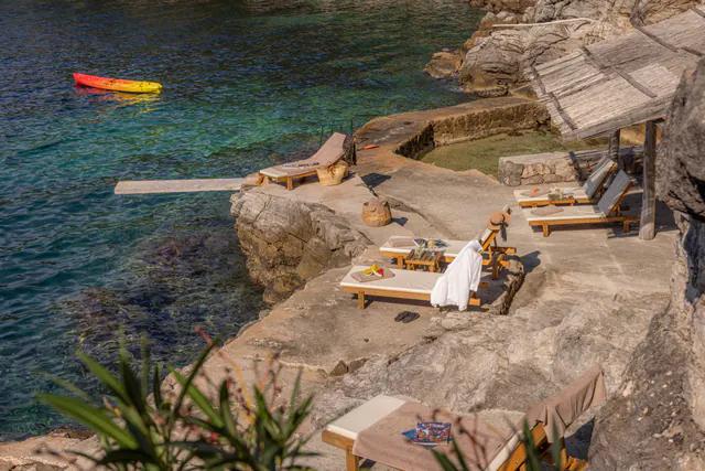 Private stone terrace furnished for relaxing above the Adriatic.