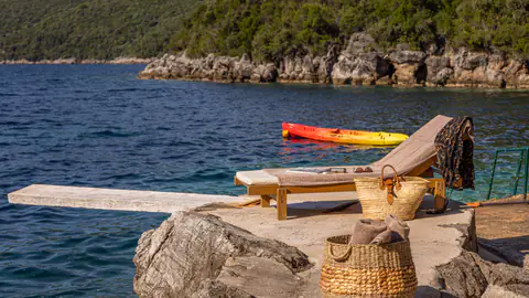 Sun loungers positioned on a quiet terrace facing the sea.