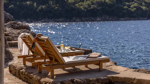 Outdoor table and chairs overlooking the blue Adriatic.