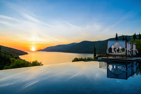 Outdoor table beside the infinity pool and Mediterranean garden.