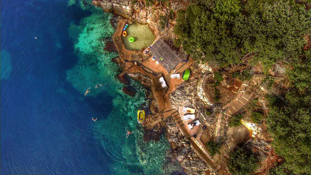 Rocky bathing cove with direct steps into the Adriatic.
