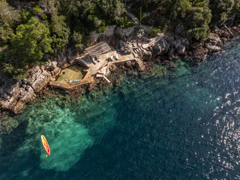Stone sea-access platform sheltered within Molonta's private cove.