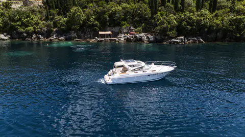 Jeanneau motor yacht cruising in the sheltered waters beside Molonta.