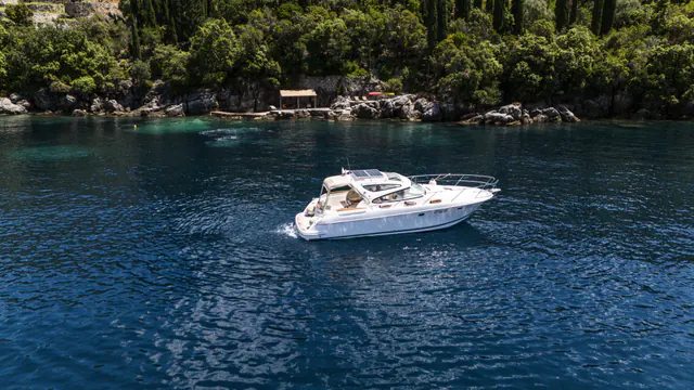 Jeanneau motor yacht cruising in the sheltered waters beside Molonta.